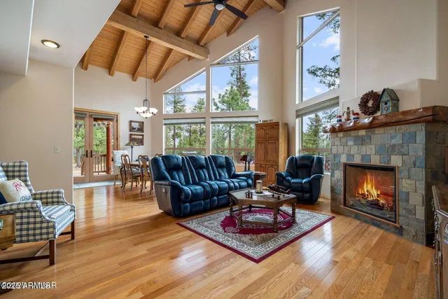 a living room with furniture fireplace and a large window