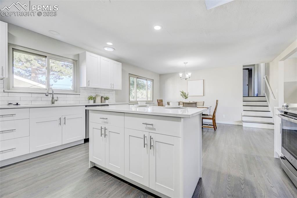 2326 Condor Street Colorado Springs, CO 80909 - Photo 11 of 47 a kitchen with white cabinets and sink