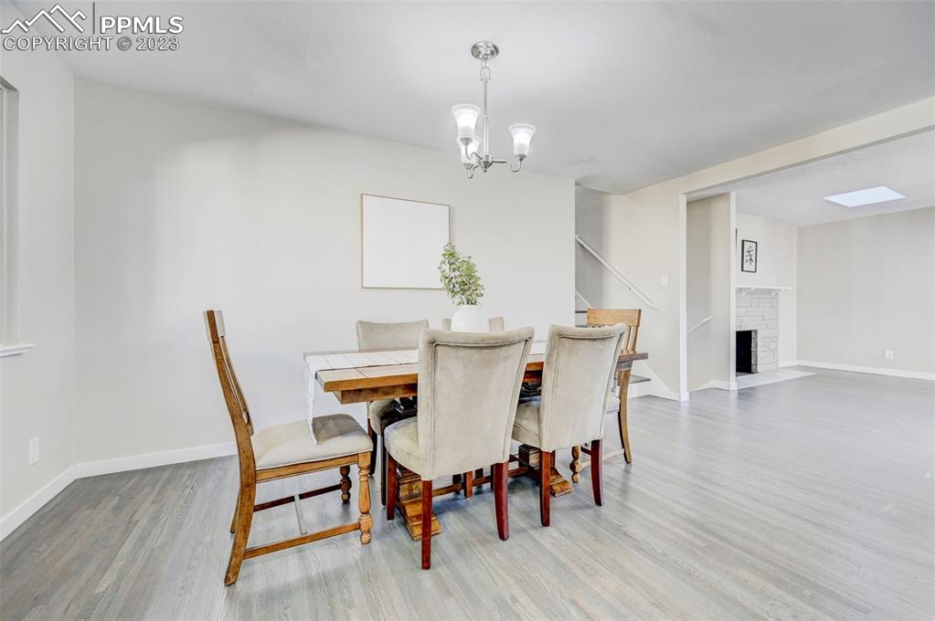 2326 Condor Street Colorado Springs, CO 80909 - Photo 13 of 47 a view of a dining room with furniture and wooden floor
