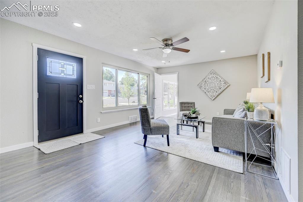 2326 Condor Street Colorado Springs, CO 80909 - Photo 14 of 47 a living room with furniture and a wooden floor