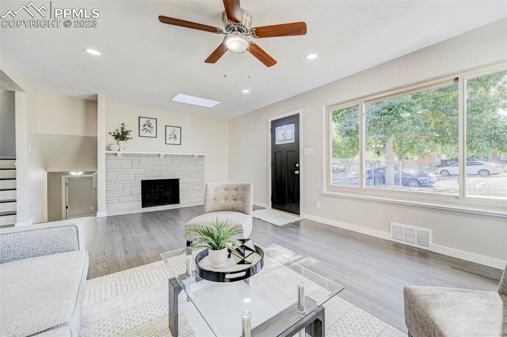 2326 Condor Street Colorado Springs, CO 80909 - Photo 16 of 47 a living room with furniture and a fireplace