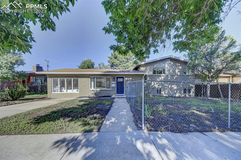 2326 Condor Street Colorado Springs, CO 80909 - Photo 2 of 47 front view of a house with a yard