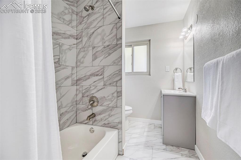 2326 Condor Street Colorado Springs, CO 80909 - Photo 25 of 47 a bathroom with a bathtub and shower