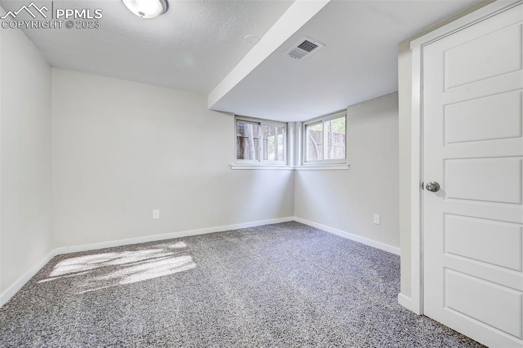 2326 Condor Street Colorado Springs, CO 80909 - Photo 32 of 47 a view of an empty room with a window