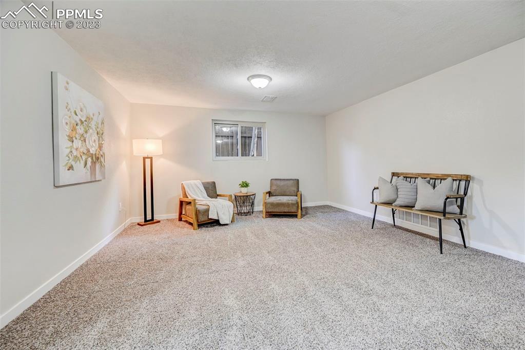 2326 Condor Street Colorado Springs, CO 80909 - Photo 35 of 47 a bed room with furniture and a lamp