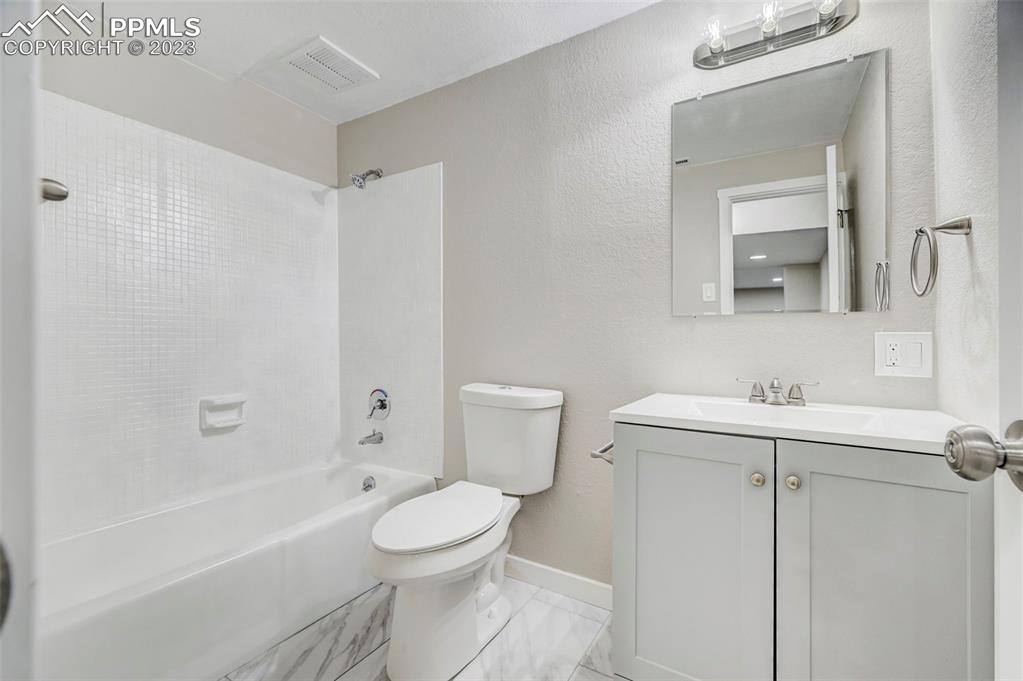 2326 Condor Street Colorado Springs, CO 80909 - Photo 45 of 47 a bathroom with a sink a toilet and shower