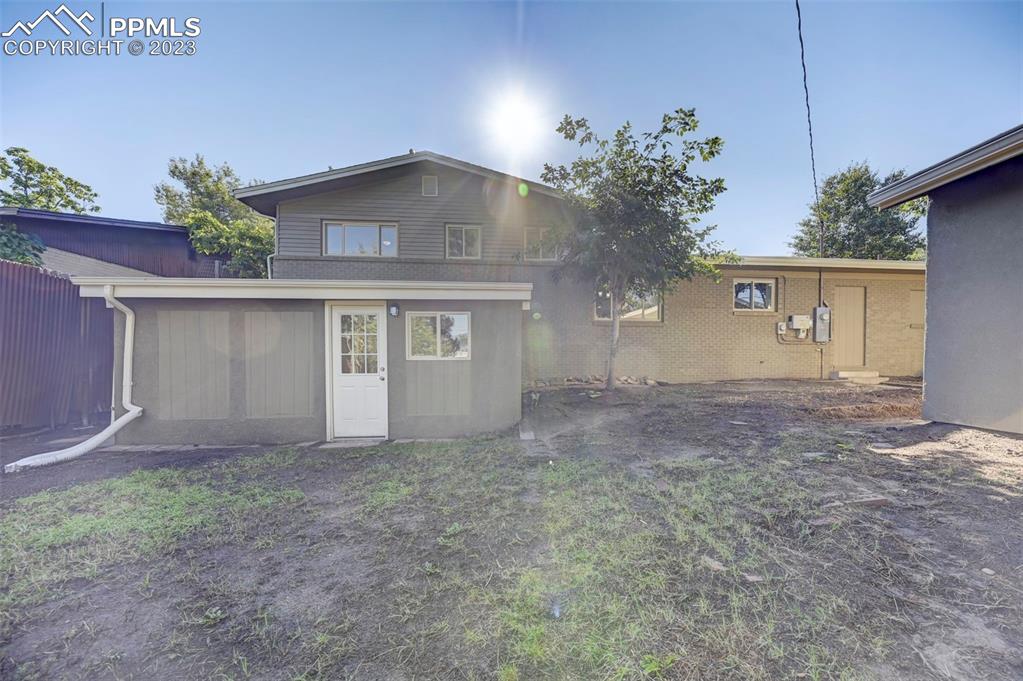 2326 Condor Street Colorado Springs, CO 80909 - Photo 47 of 47 a view of a house with a yard and garage