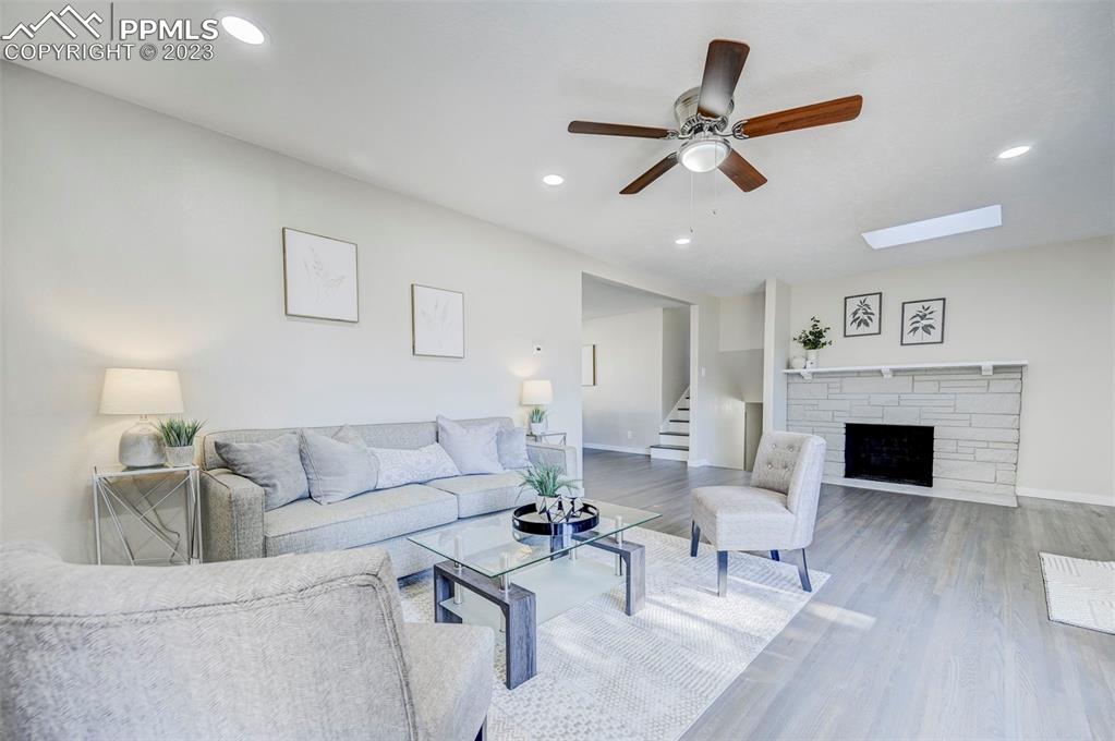 2326 Condor Street Colorado Springs, CO 80909 - Photo 6 of 47 a living room with furniture and a fireplace