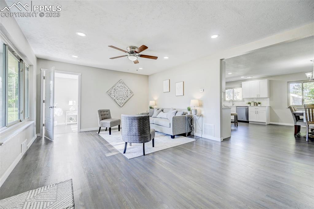 2326 Condor Street Colorado Springs, CO 80909 - Photo 7 of 47 a living room with furniture a view of kitchen and a wooden floors