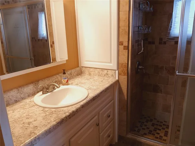 a bedroom with a bed and a dresser with rug