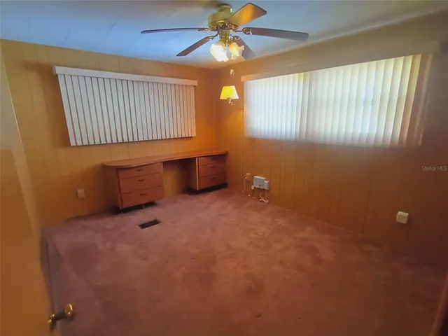 a white toilet sitting next to a white cabinet