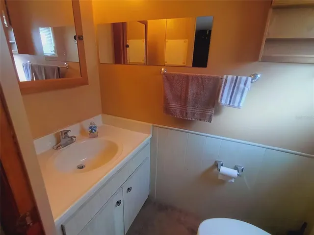 a living room with furniture a rug and a flat screen tv