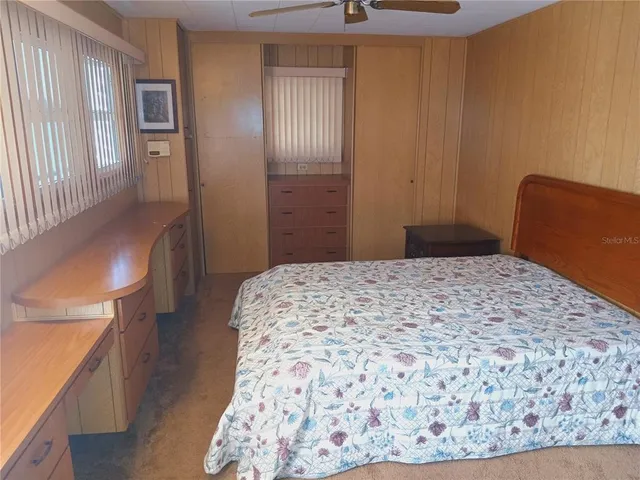 a kitchen with a sink a refrigerator and cabinets