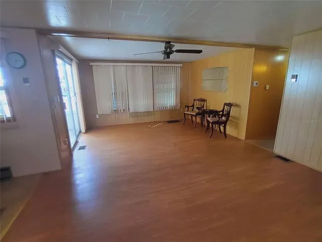 a kitchen with stainless steel appliances a sink a stove a microwave a sink a refrigerator and cabinets