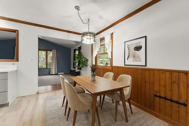 a view of an empty room with wooden floor and a ceiling fan