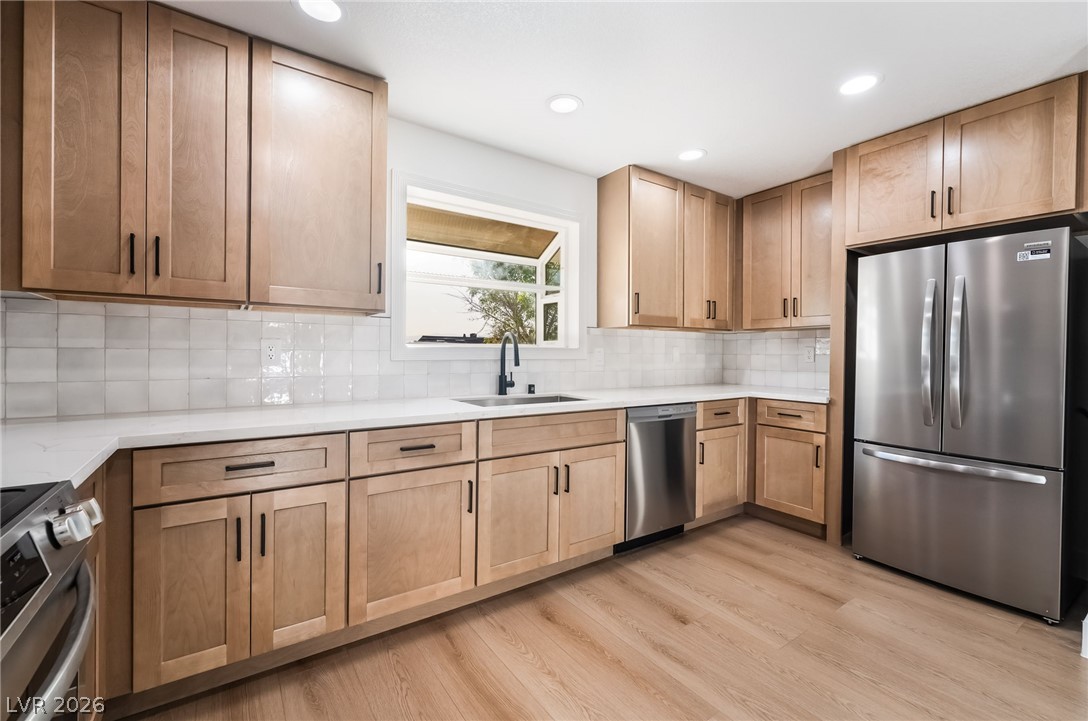 429 Crestway Road Henderson, NV 89015 - Photo 19 of 56 A well-appointed culinary space featuring light wood cabinetry and resilient flooring for daily living.