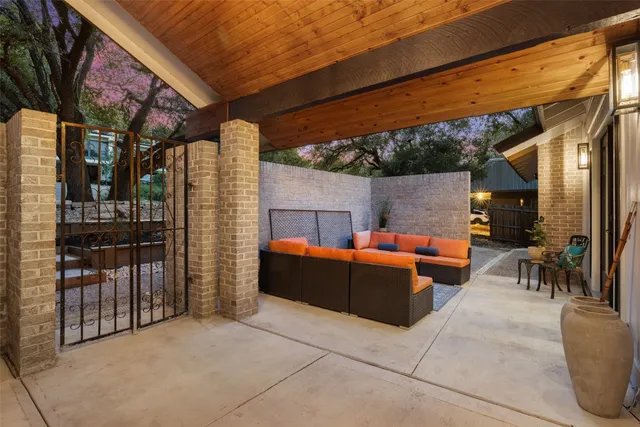a view of a patio with couches and table and chairs and potted plants