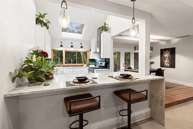 a kitchen with a table and chairs in it