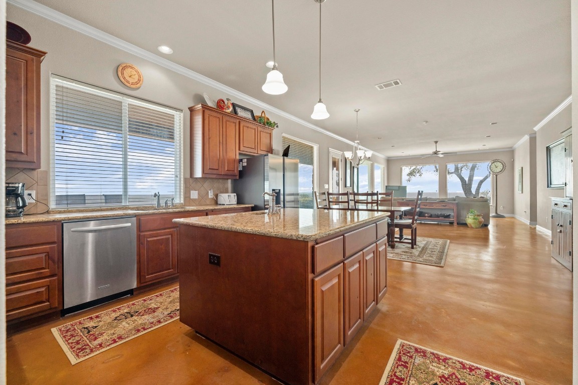 28701 Valley Road Marble Falls, TX 78654 - Photo 11 of 36 a kitchen with stainless steel appliances granite countertop a stove a sink dishwasher and a refrigerator with wooden floor