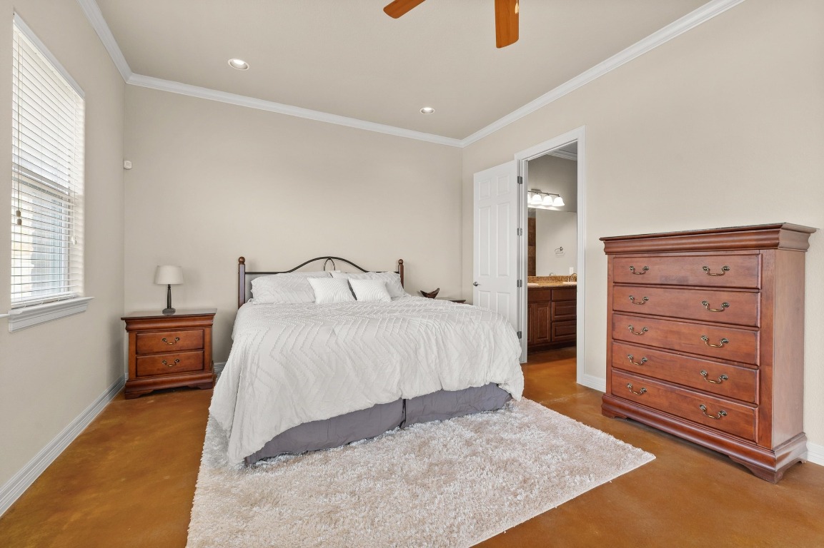 28701 Valley Road Marble Falls, TX 78654 - Photo 14 of 36 a bedroom with a bed and a dresser