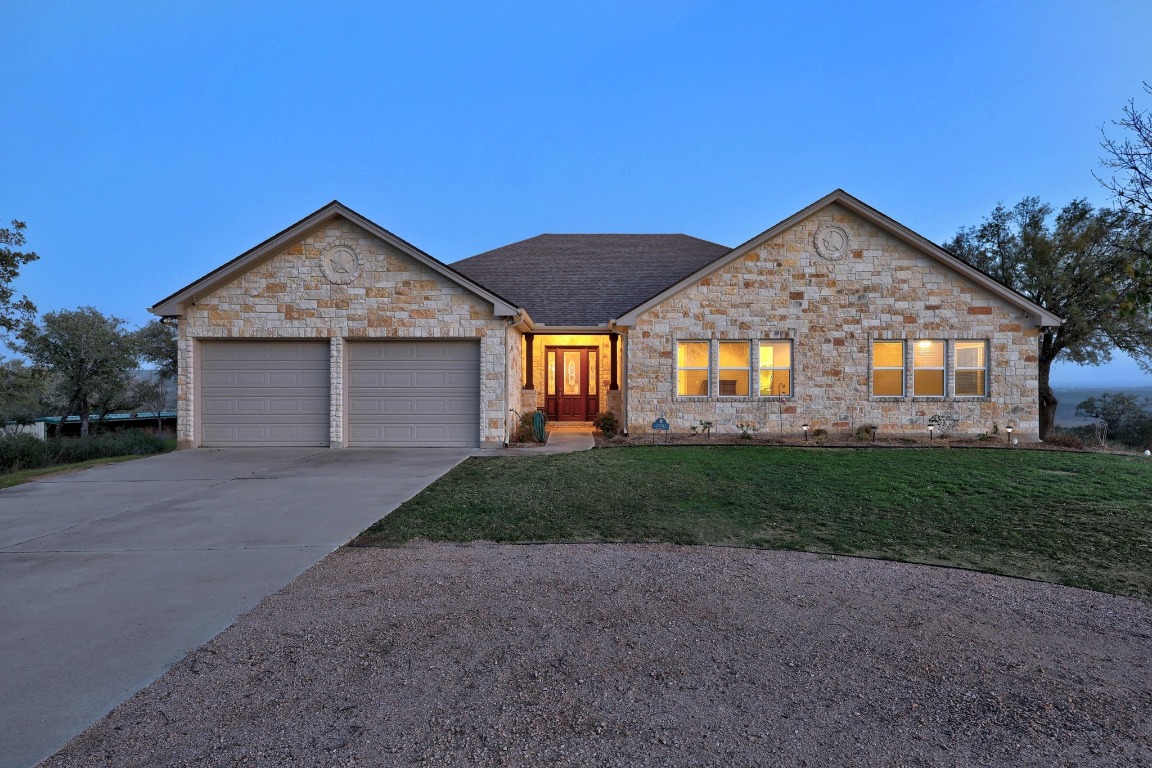 28701 Valley Road Marble Falls, TX 78654 - Photo 36 of 36 a front view of a house with a yard and garage