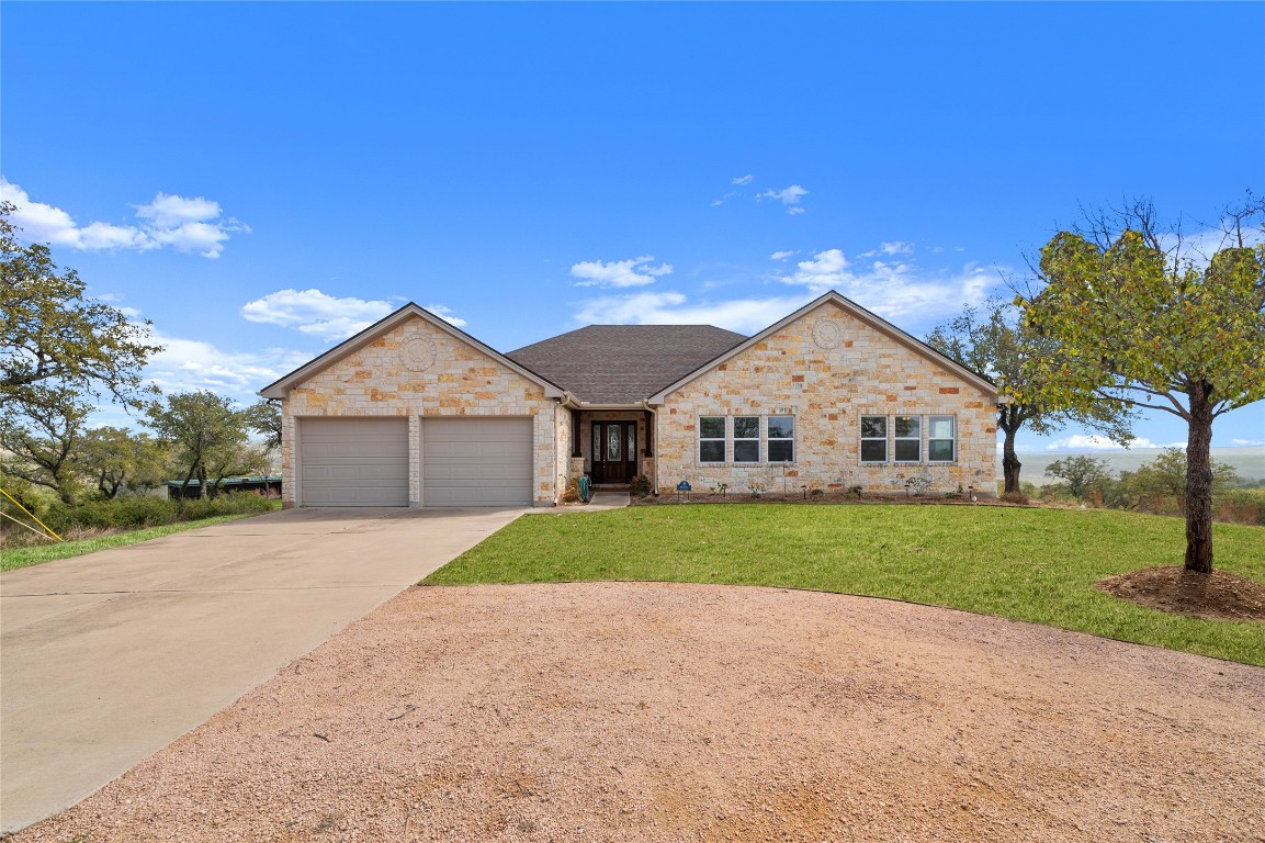 28701 Valley Road Marble Falls, TX 78654 - Photo 4 of 36 a front view of a house with a yard and garage