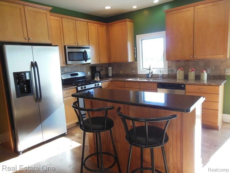 3225 Outback Trail Pinckney, MI 48169 - Photo 23 of 76 MAPLE CABINETS, HARD WOOD FLOORS, GRANITE THROUGH OUT