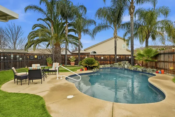 a view of a swimming pool with a table and chairs