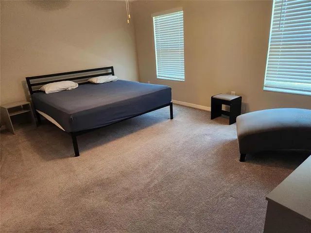 a bedroom with furniture and a window