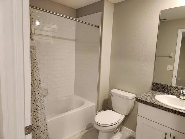 a white toilet sitting next to a bath tub