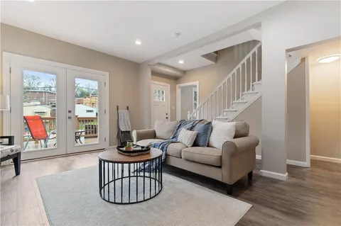 a living room with furniture a window and a ceiling fan