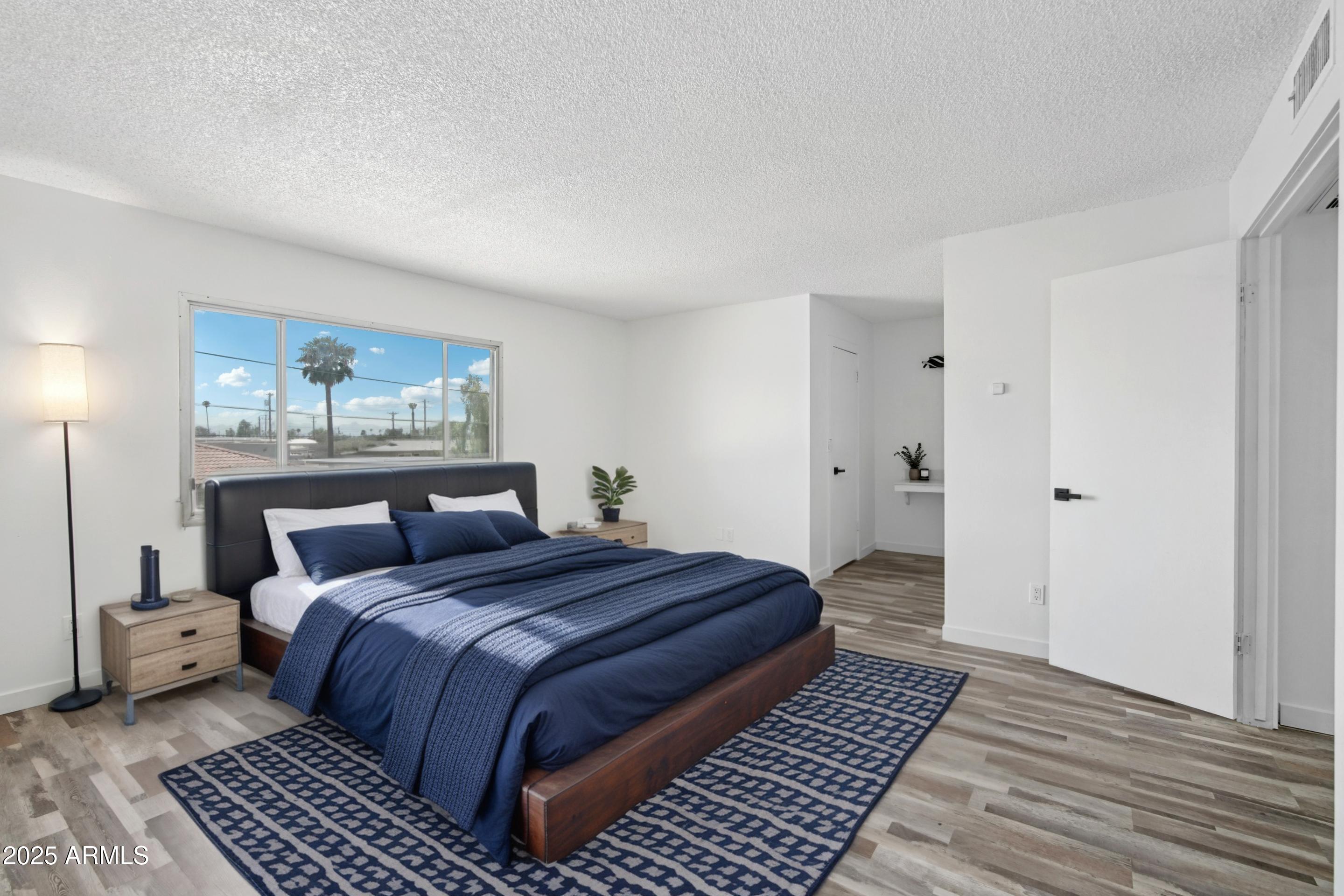 4606 North 19th Avenue Phoenix, AZ 85015 - Photo 15 of 36 a bedroom with double bed and a window
