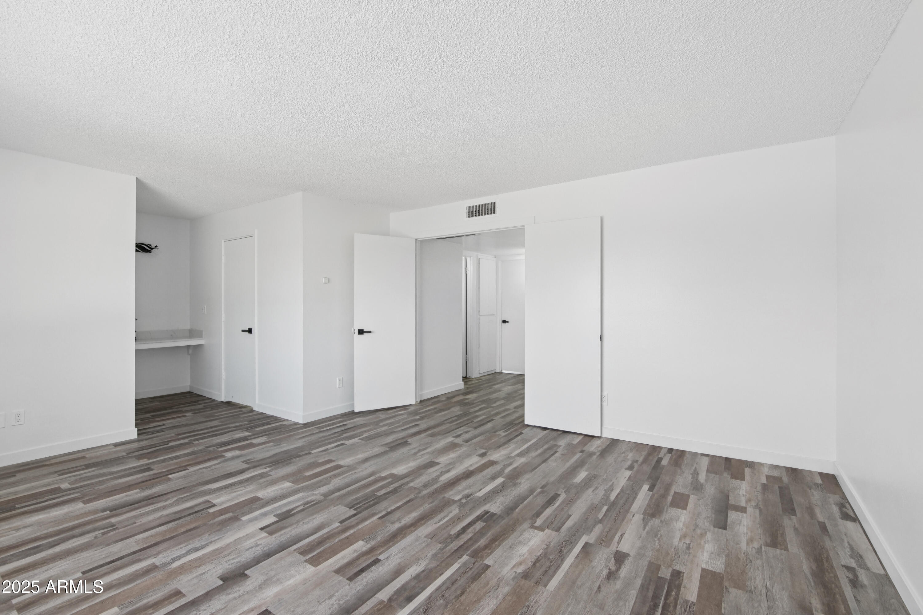 4606 North 19th Avenue Phoenix, AZ 85015 - Photo 16 of 36 a view of an empty room and wooden floor