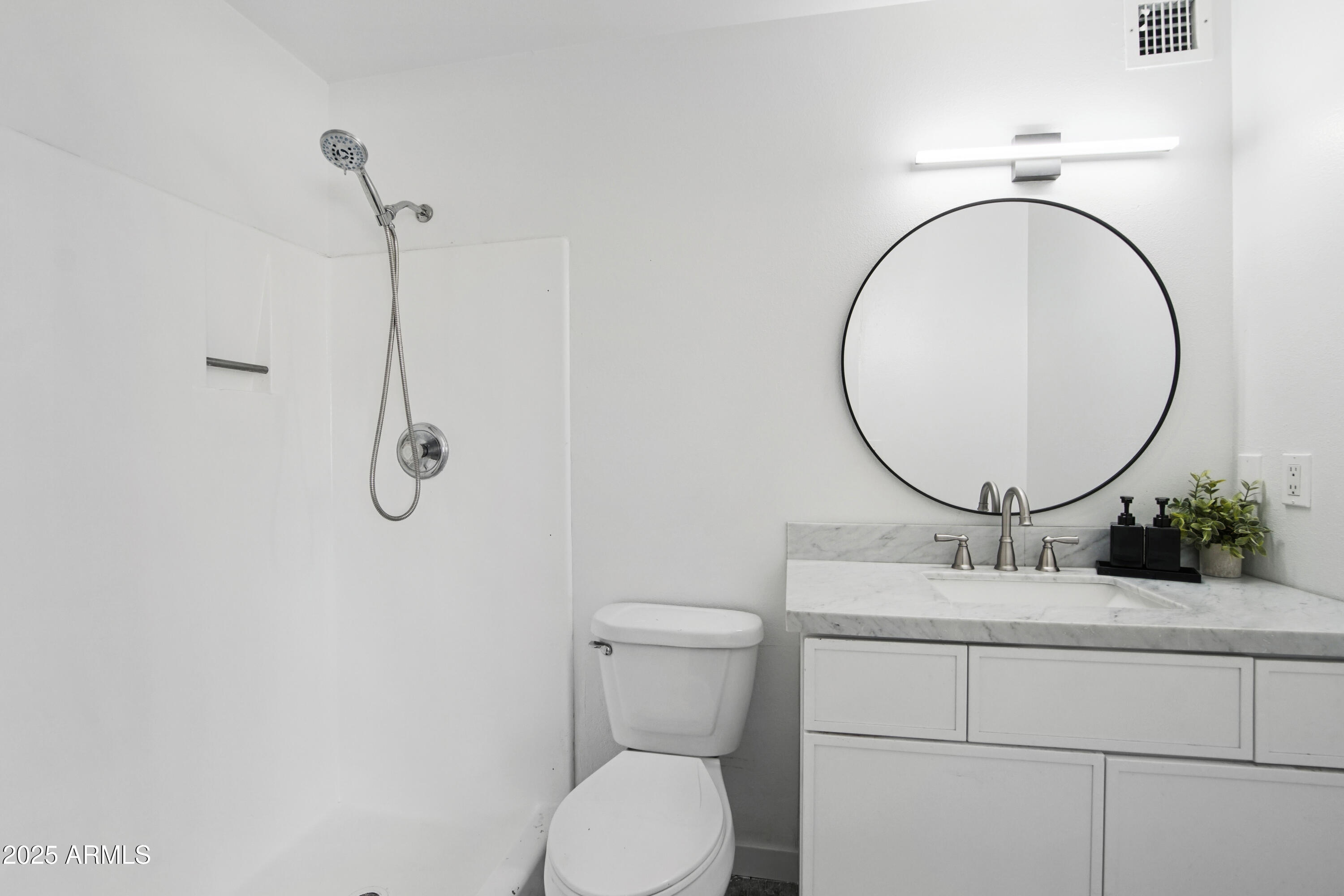 4606 North 19th Avenue Phoenix, AZ 85015 - Photo 18 of 36 a bathroom with a sink mirror vanity and toilet