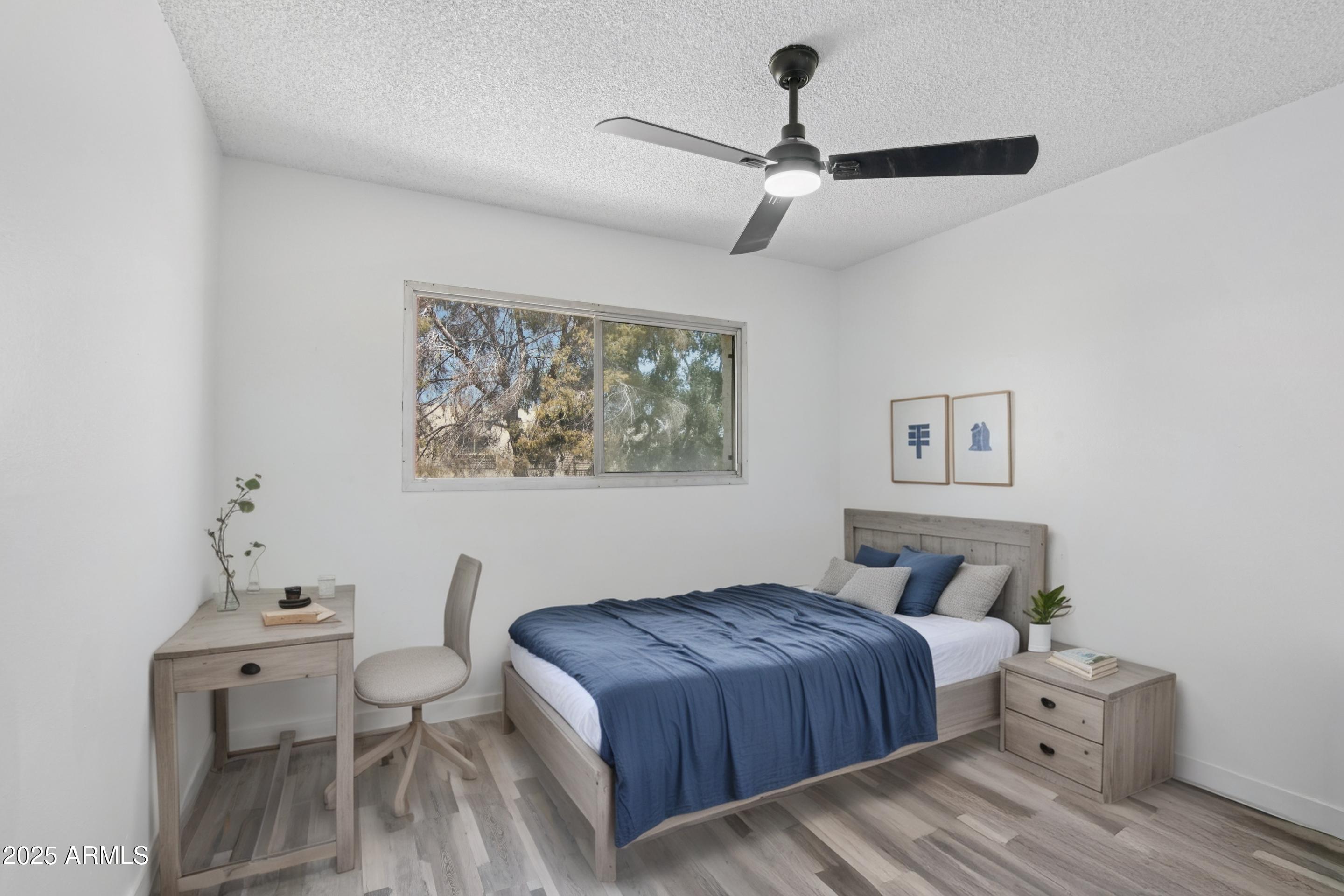 4606 North 19th Avenue Phoenix, AZ 85015 - Photo 20 of 36 a bedroom with a bed and a painting on the wall