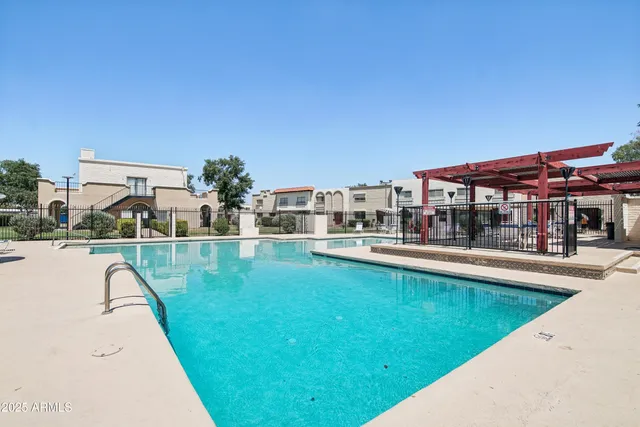 a view of a house with swimming pool and a yard