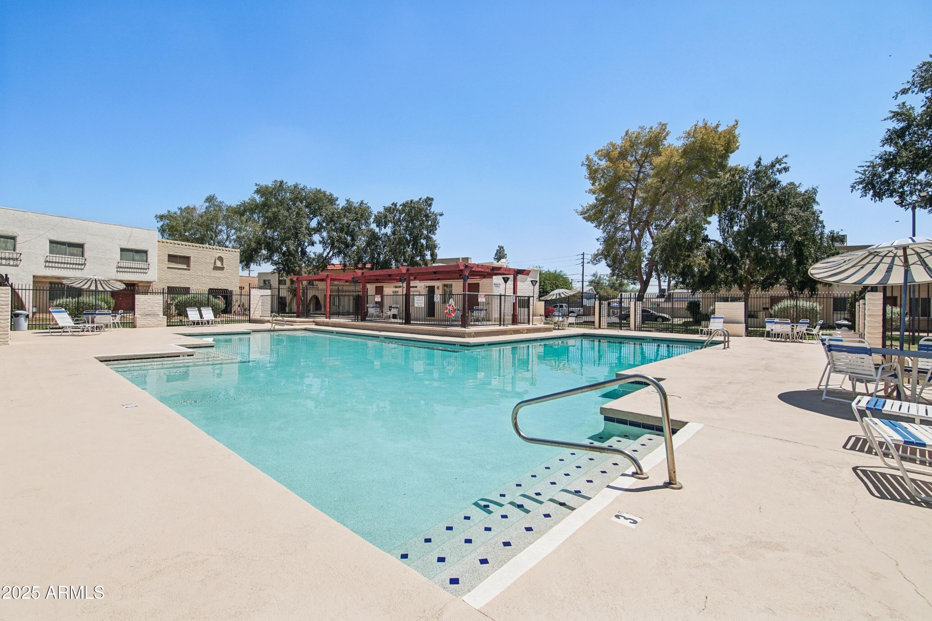 4606 North 19th Avenue Phoenix, AZ 85015 - Photo 30 of 36 a view of a swimming pool with outdoor seating and yard in the back