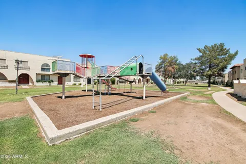 a view of a swimming pool with outdoor seating and yard in the back