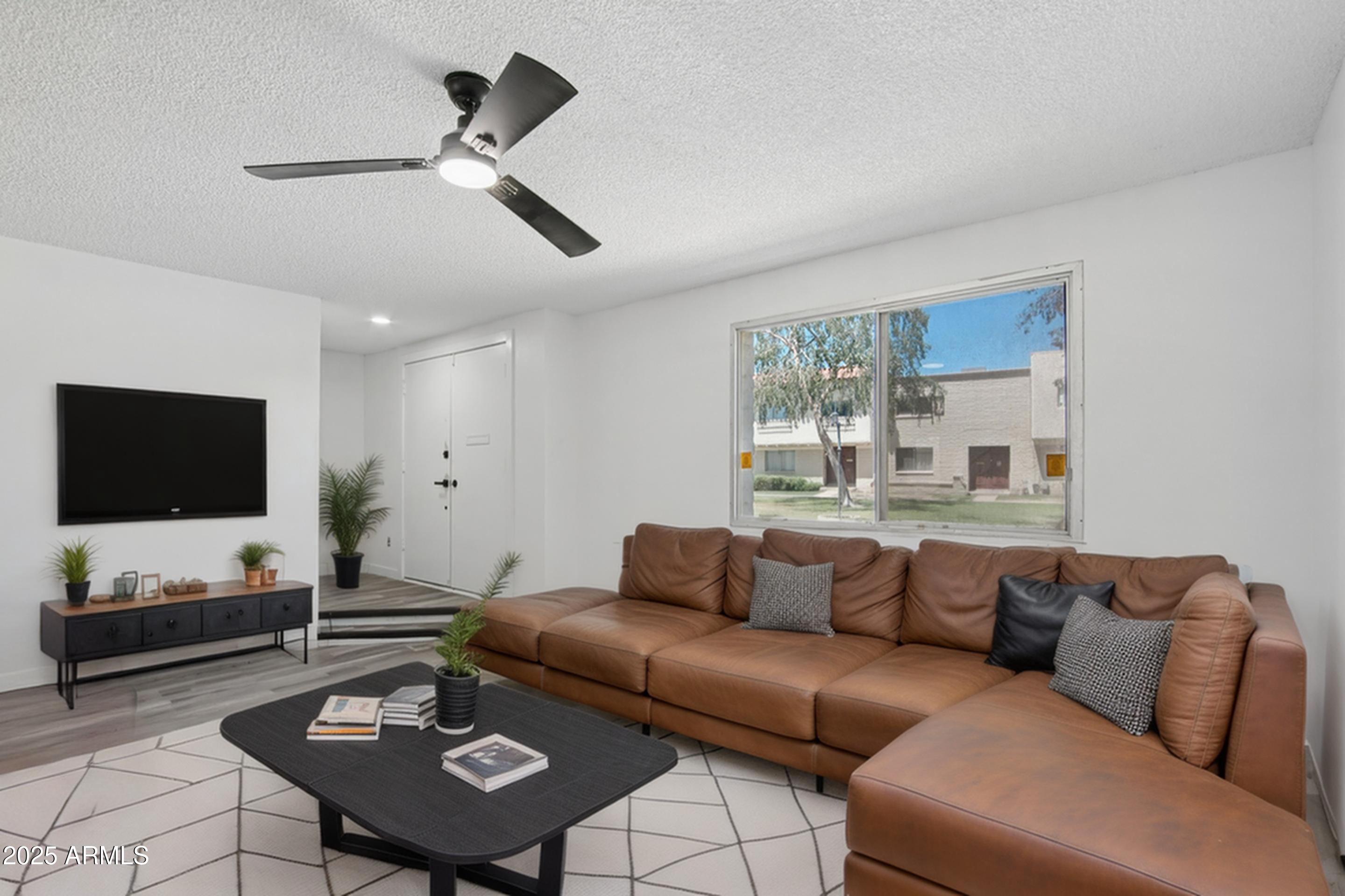 4606 North 19th Avenue Phoenix, AZ 85015 - Photo 3 of 36 a living room with furniture and a flat screen tv