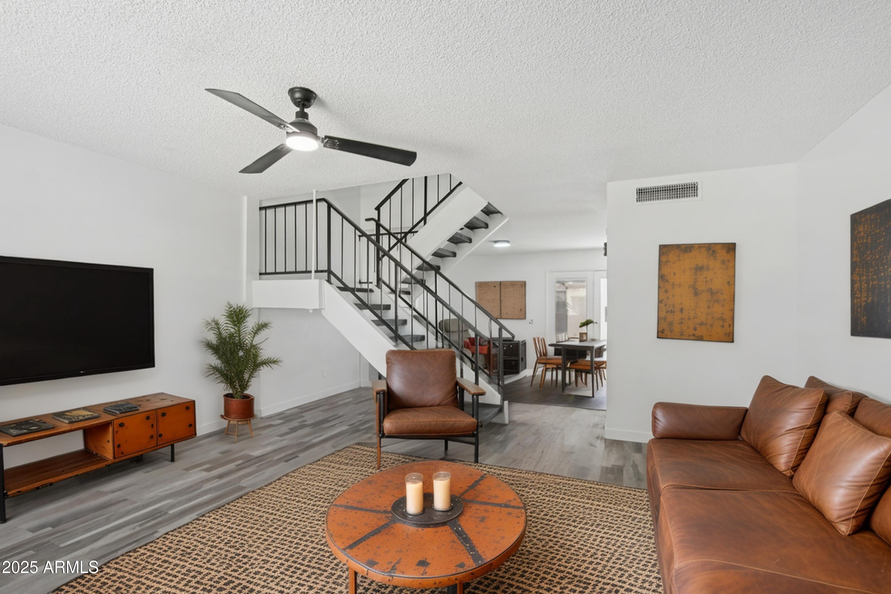 4606 North 19th Avenue Phoenix, AZ 85015 - Photo 5 of 36 a living room with furniture and a flat screen tv