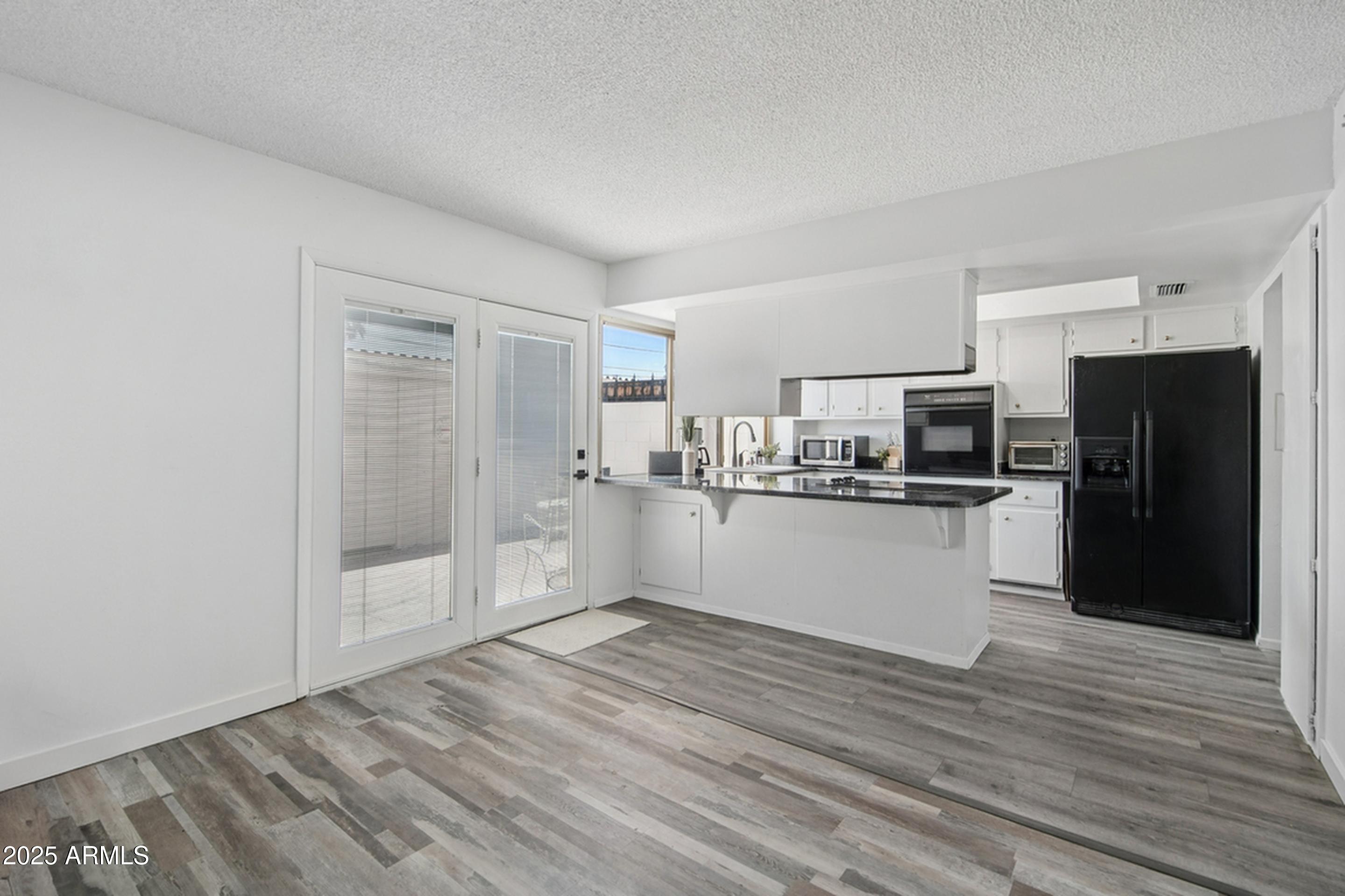 4606 North 19th Avenue Phoenix, AZ 85015 - Photo 8 of 36 a view of kitchen refrigerator and cabinets