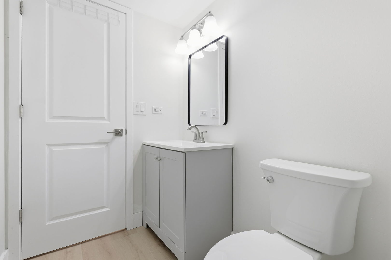 382 Oak Trails Road, Unit 301 Des Plaines, IL 60016 - Photo 14 of 24 a bathroom with a toilet a sink and mirror