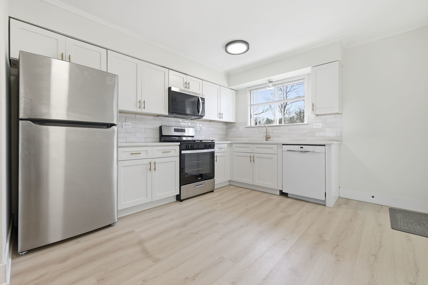 382 Oak Trails Road, Unit 301 Des Plaines, IL 60016 - Photo 7 of 24 a kitchen with white cabinets and white appliances