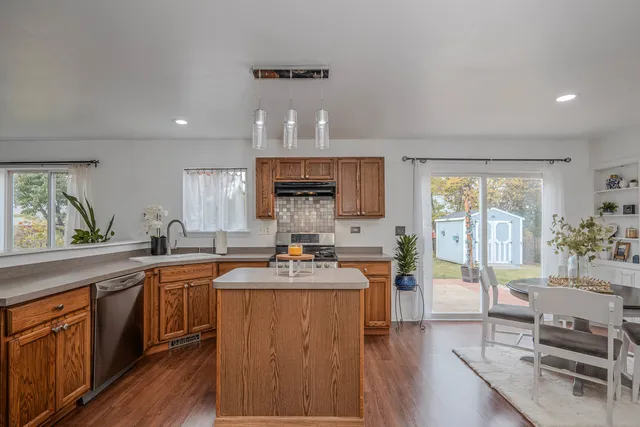 a kitchen with a sink a counter top space and stainless steel appliances