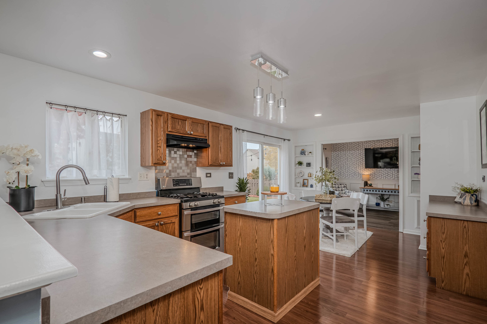 215 Alexis Street Plano, IL 60545 - Photo 14 of 42 a kitchen with stainless steel appliances granite countertop a sink stove and wooden cabinets