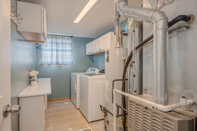 a storage room with wooden floor washer and dryer