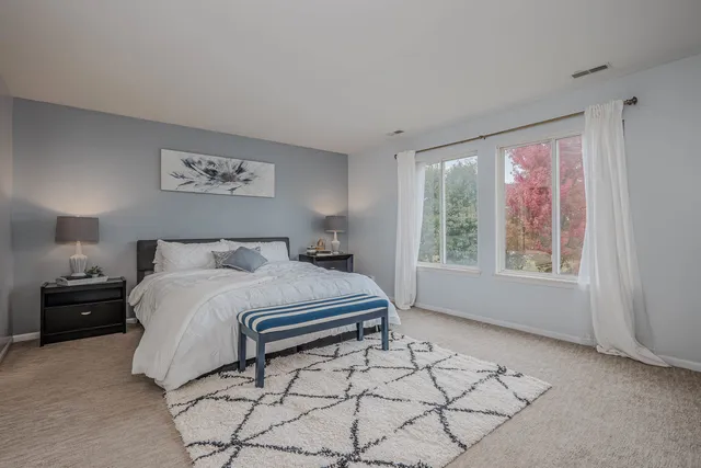 a bedroom with a bed and a window