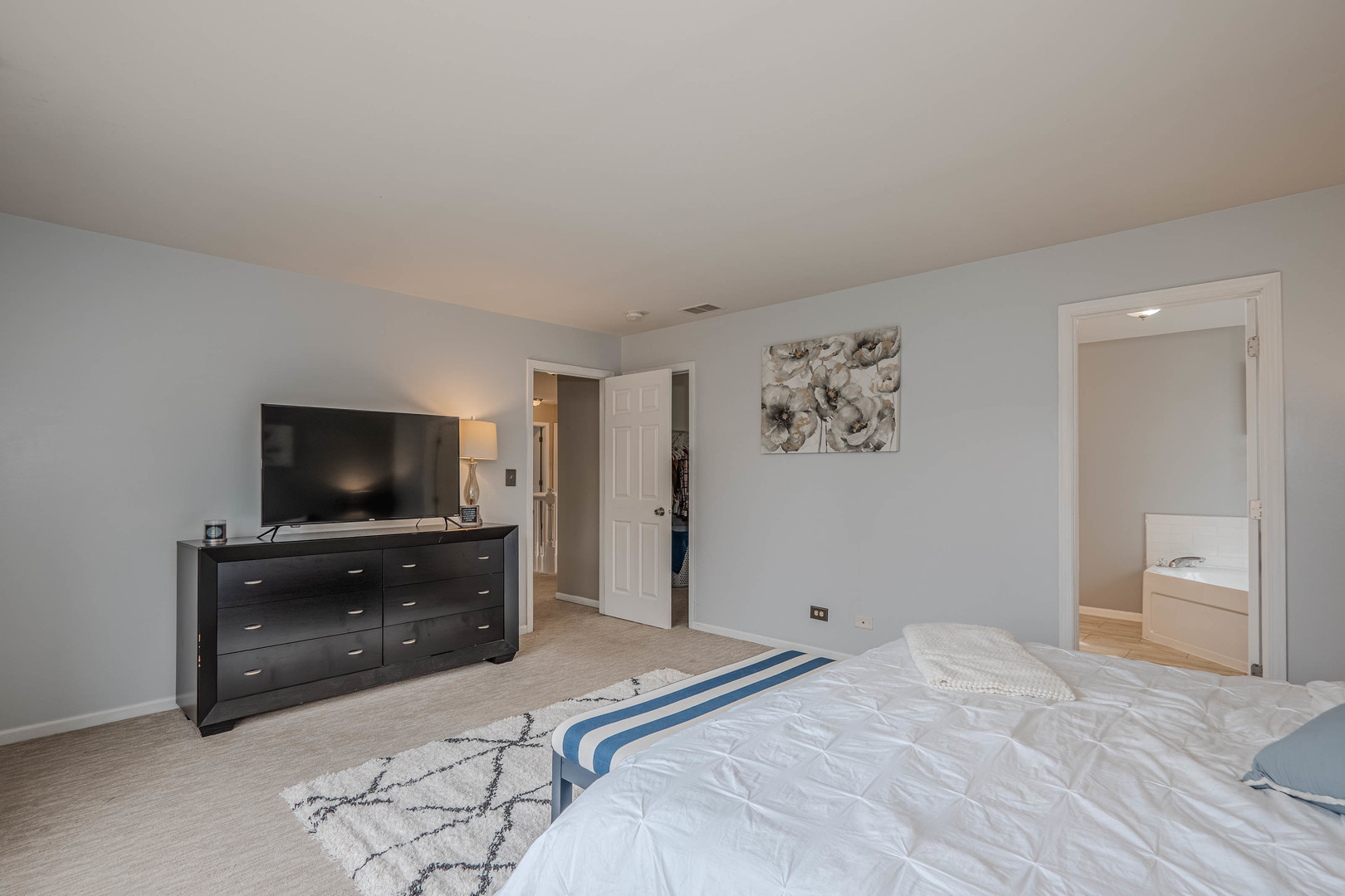 215 Alexis Street Plano, IL 60545 - Photo 26 of 42 a bedroom with a bed and a flat screen tv on a dresser