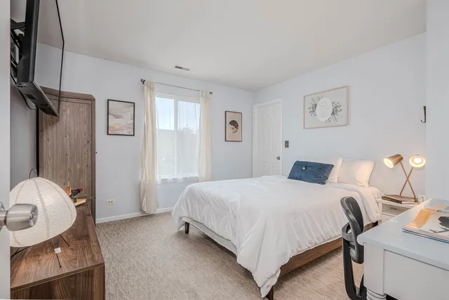 a bedroom with a bed and dresser