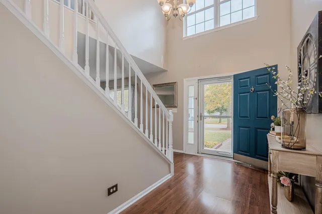a view of a hallway with wooden floor and entryway